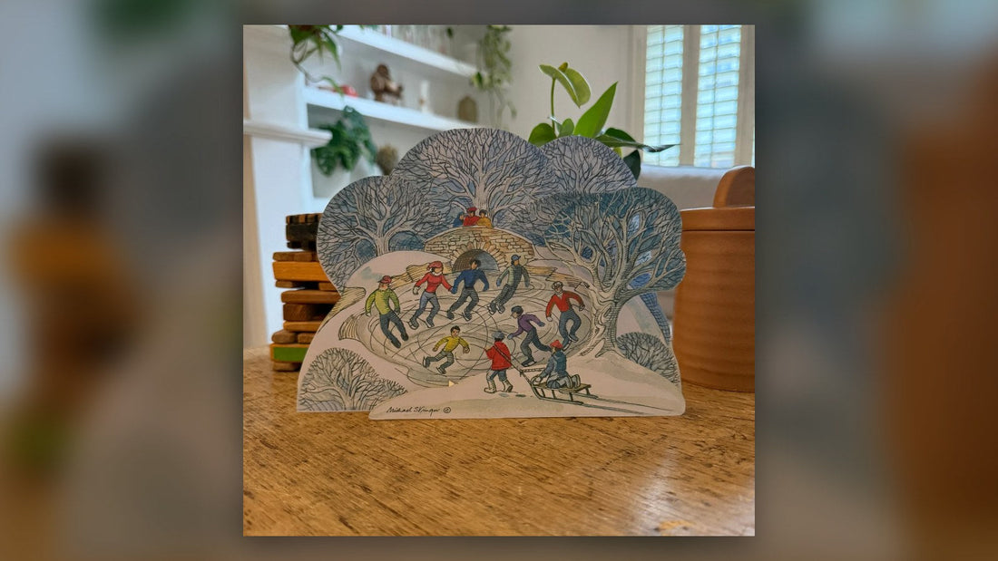 Skaters on the Pond Christmas card standing on a wooden table
